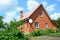 Cozy brick house with antenna and metal roof