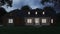 Cozy brick house with a large garden and lawn. Home exterior. Twilight, night lighting.