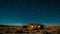 A cozy cabin in the middle of a vast desert where guests can drift off to sleep under a canopy of stars and wake up to a