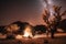 cozy campsite under starry night sky in desert