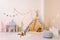 Cozy child room interior with play tent, table and decor elements