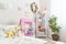 Cozy children room for little girl, with white wall with pictures, Dollhouse