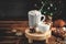 Cozy Christmas composition.Two mug with hot drinks, chocolate with whipped cream and cappuccino with cinnamon stick on a