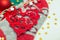 Cozy Christmas decorations close-up, red heart figurine and warm knitted socks