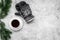 Cozy christmas evening. Coffee and knitten mittens on grey stone background top view copyspace
