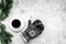 Cozy christmas evening. Coffee and knitten mittens on grey stone background top view copyspace