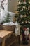 Cozy Christmas house interior. Christmas tree with decor, bench with basket, blankets and pillows