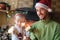 Cozy christmas or New Year home family celebrating. Smiling father and son with sparkles clutched in hands sitting near fireplace