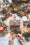 Cozy Christmas preparation. Female hands write Christmas greeting card on white blanket with open gift box with funny socks,