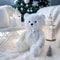 Cozy Christmas scenery with a white knitted teddy bear and white knit blankets
