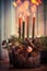 Cozy Christmas time at home. Advent wreath with four burning candles. Winter decor interior with warm bokeh lighting