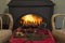 Cozy christmas or winter holidays concept. Burning wooden stove, two chair a