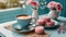 Cozy coffee break with pink macarons at cafe table. Delicious hot drink and sweet dessert