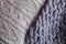 Cozy composition, closeup merino wool plaid in bed, warm and comfortable atmosphere. Knit background