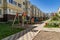 Cozy courtyard between houses with green plants and attractions for children.