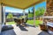 Cozy covered patio with stone trim fireplace.