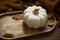 Cozy dark autumnal decoration with pumpkin, dried leaves and knitted cozy blanket on old wooden table tray