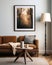 Cozy, earth-toned living room, spotlight on a framed mockup painting illuminated by a warm floor lamp, shot with a soft