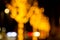 Cozy evening in the festive city. Blurred image of trees decorated with light garlands for Christmas and New Year celebration time