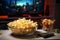 In a cozy evening, a glass bowl of popcorn awaits TV