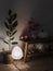 Cozy evening interior - a vase with cranberry branches, a pumpkin pillow, a candle on an oak bench, a homemade ficus flower in a