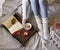 Cozy fall indoor female with woolen socks, coffee and candle, so