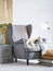 Cozy gray colored armchair in home interior.