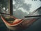 Cozy hammock on a veranda, in a misty forest. Comfortable place to relax, take a break, meditate, have a nap. Generative AI