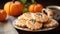 Cozy home autumn atmosphere Delicious glazed homemade gingerbread cookies on a table with autumn leaves and pumpkins.