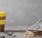 Cozy home scene - a stack of old read newspapers, glasses and a glass of coffee on a wooden table