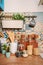 Cozy home style modern kitchen with colorful patchwork tiles, spice jars, glass jars with cereals and other kitchen accessories