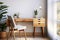 Cozy home workplace with wooden drawer writing desk and fabric chair. Interior design of modern Scandinavian home office