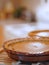 Cozy, homey image of two pumpkin pies cooling in a kitchen. Backlighting and shallow depth of field used. Image is in warm tones t