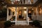 cozy house with wrap-around porch and lanterns for a warm and welcoming exterior