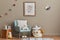Cozy interior of child room with mint armchair, brown mock up poster frame, toys, teddy bear, plush animal, decoration.