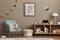 Cozy interior of child room with mint armchair, brown mock up poster frame, toys, teddy bear, plush animal, decoration.