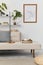 Cozy interior with stylish sofa, design coffee table, bookcase, plants, carpet, decoration, mock up poster map