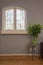 Cozy little vintage window with colorful flower bush on the table