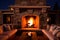 Cozy living outdoor interior with crackling stone fire in beautiful fireplace and furniture