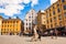 Cozy medieval streets and squares with attractions, walking people, working businesses, multicolor buildings facades in Gamla Stan