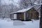 Cozy modular simple house in winter forest. Hygge lifestyle concept.