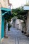 Cozy narrow beautiful street in the old turkish town Alacati, Turkey with houses twined with bougainvillea