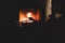 Cozy night in the cabin by the fireplace, fireplace burns in the scandinavian cottage chalet house, burning fire with charcoal and