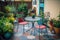 cozy outdoor patio with bistro table, chairs, and colorful potted plants