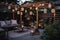 cozy outdoor patio with hanging lanterns and blooming flowers