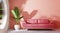 Cozy pastel pink sofa in modern living room with banana plant and look through glass window garden outside outdoor view on