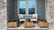 A cozy peaceful front porch of a house with adirondack chairs and flower planters