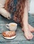 Cozy photo of woman feet with tea and cake