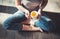 Cozy photo of young woman with cup of tea sitting on the floor