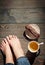 Cozy photo of young woman feet with tea and cake on the floor